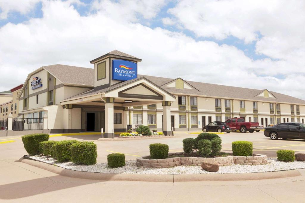 a hotel with a sign on the front of it at Baymont by Wyndham Oklahoma City Airport in Oklahoma City