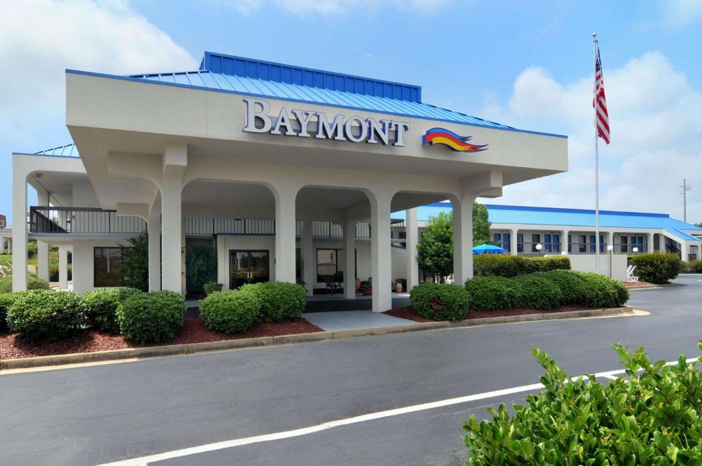 a restaurant with a sign on the front of a building at Baymont by Wyndham Macon I-75 in Macon