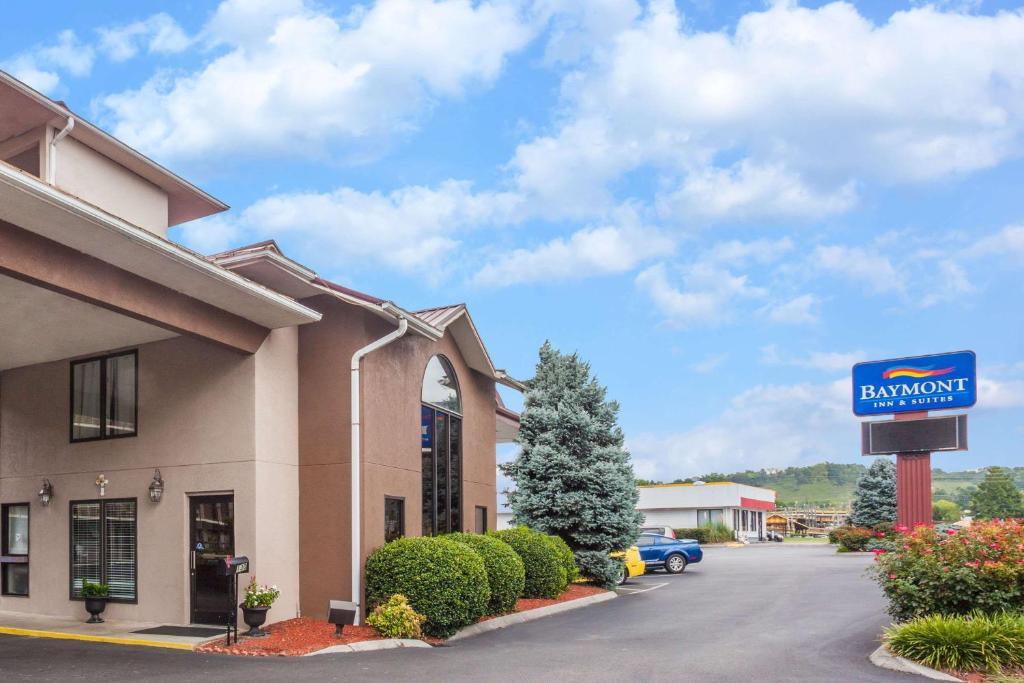 a sign in front of a building with a dealership at Baymont by Wyndham Pigeon Forge near Island Drive in Pigeon Forge