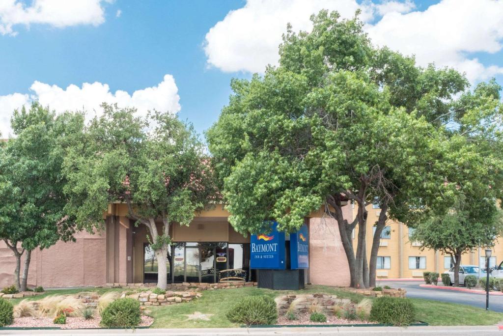 a building with trees in front of it at Baymont by Wyndham Midland Airport in Midland