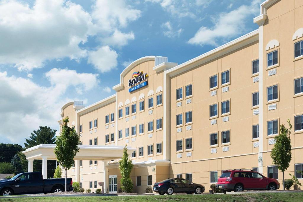 a hotel with cars parked in front of it at Baymont by Wyndham Erie in Erie