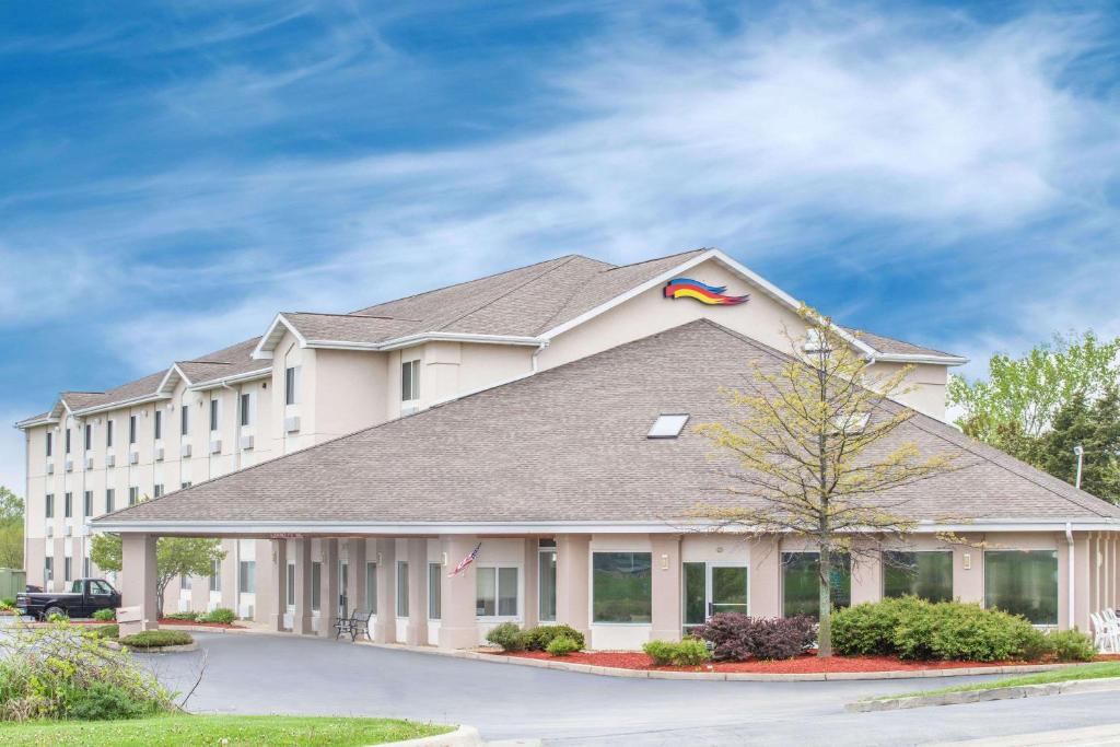 a large white building with a kite on the roof at Baymont by Wyndham Freeport in Freeport