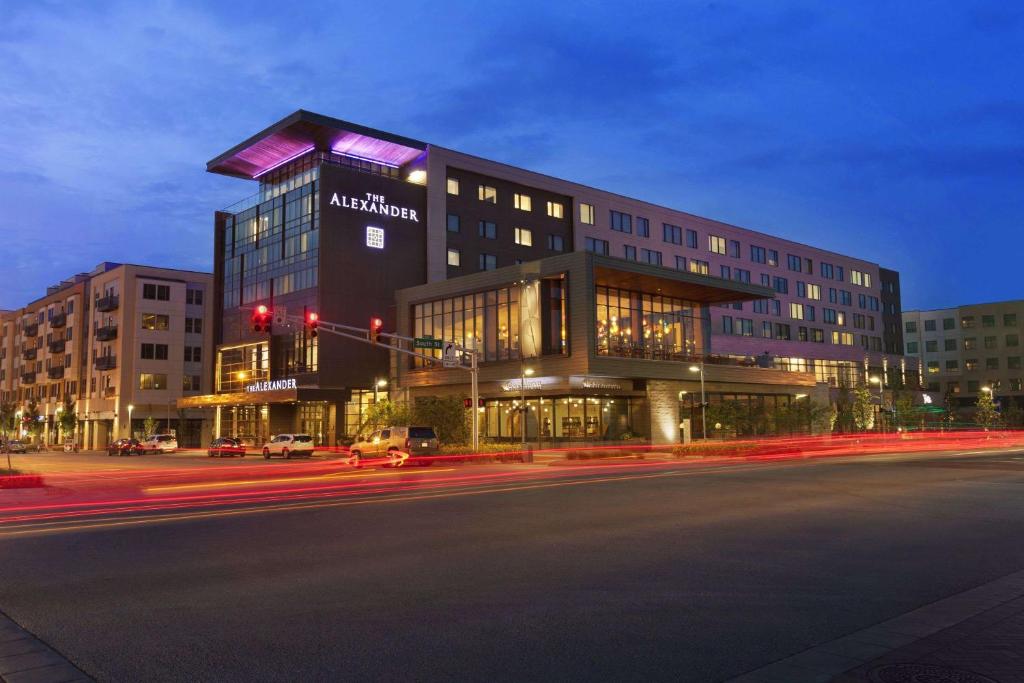 a large building on a city street at night at The Alexander, A Dolce Hotel in Indianapolis