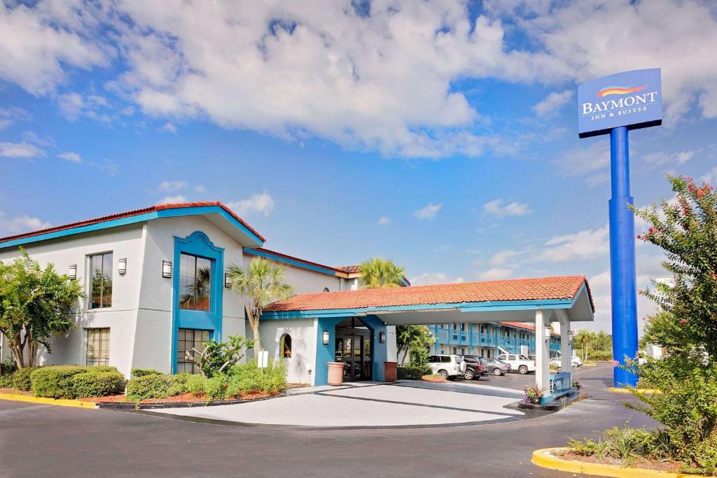 a front view of a hotel with a gas station at Baymont by Wyndham Jacksonville Orange Park in Jacksonville