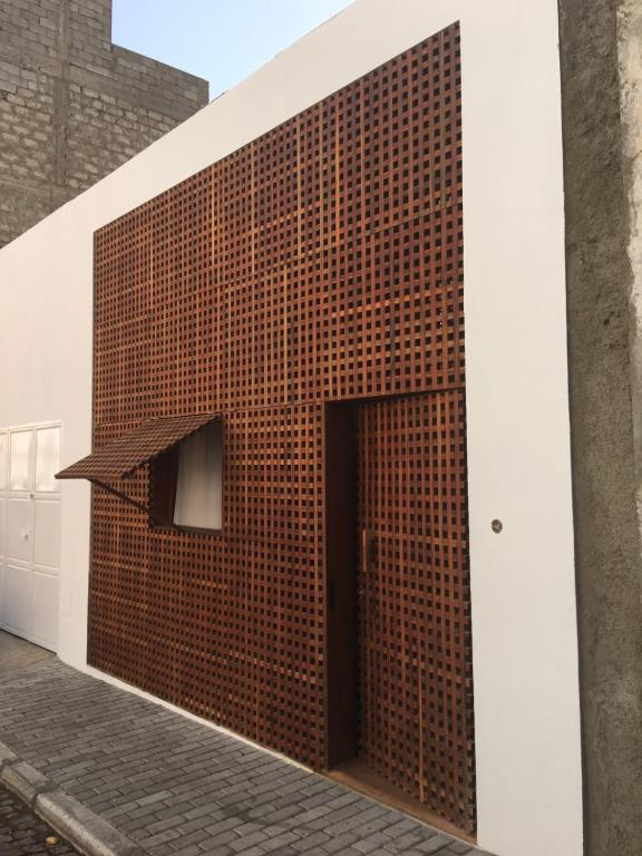 a brick wall with a door on a building at Studio M in Mindelo