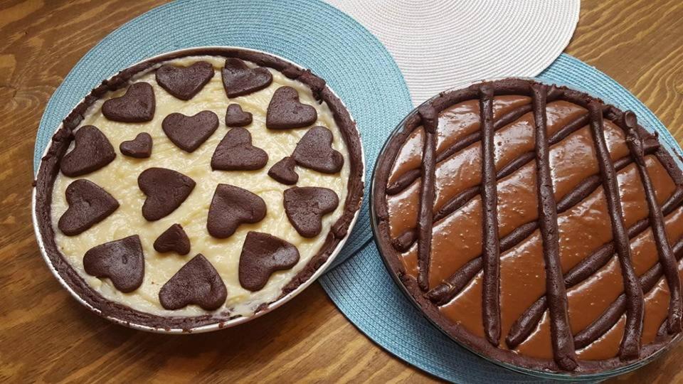 two chocolate pies on plates on a table at L'Oasi Villaggio Albergo in Favignana