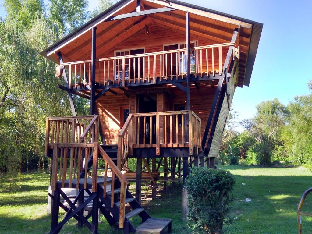 a tree house with stairs leading up to it at COEMBOTA Cabañas in Tigre