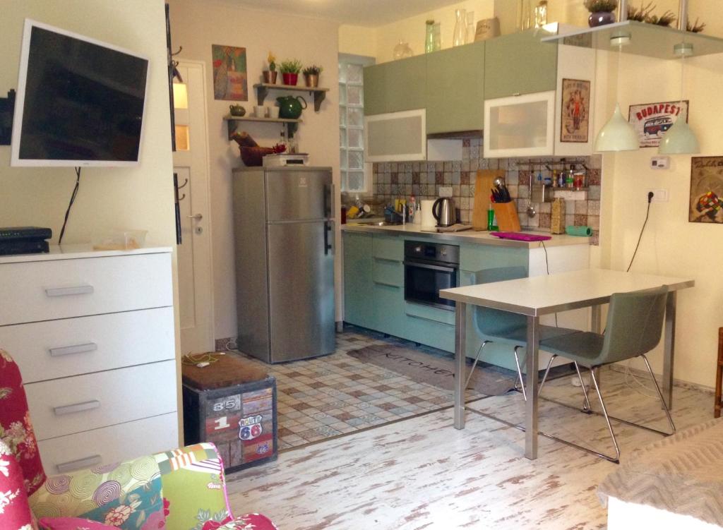a kitchen with a table and a refrigerator at Studio Karma in Budapest