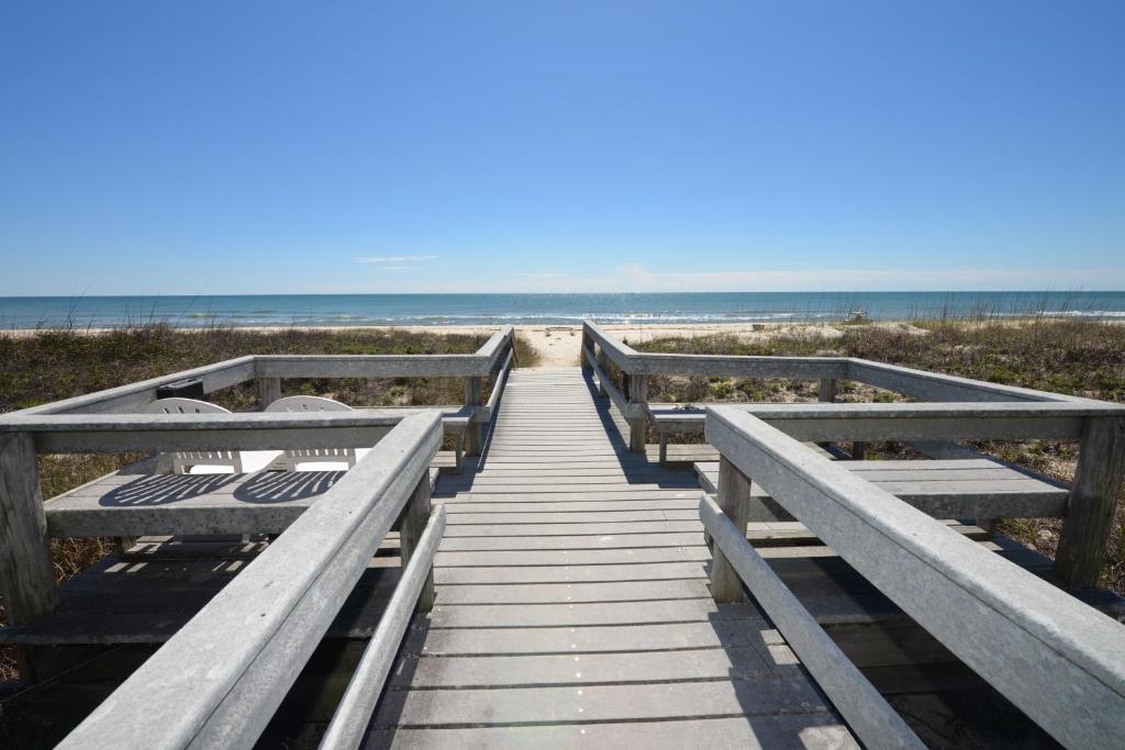 a boardwalk to the beach with the ocean in the background at Buccaneer Inn in St. George Island
