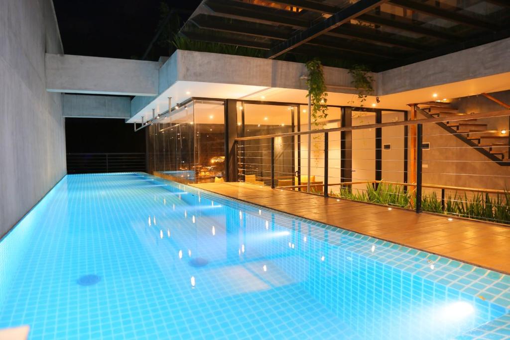 a large swimming pool in front of a building at Lakewood Residence in Kandy