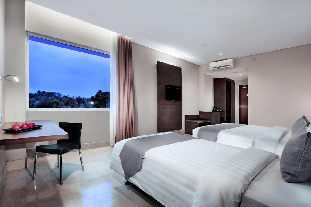 Postel nebo postele na pokoji v ubytování Hotel Neo+ Balikpapan by ASTON