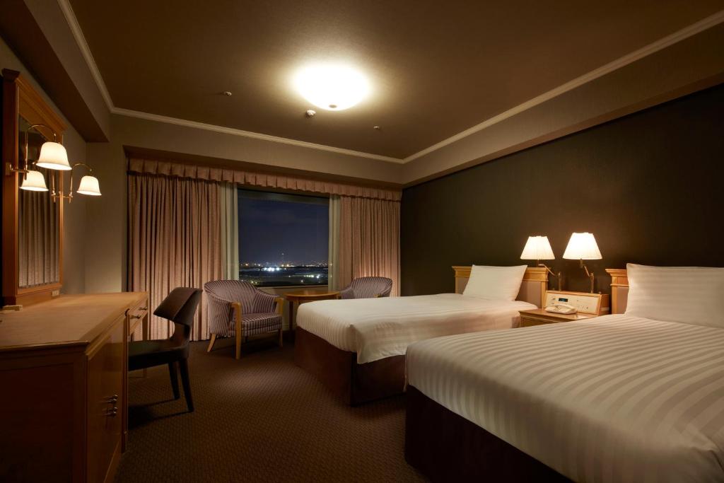 Postel nebo postele na pokoji v ubytování Hotel Agora Regency Osaka Sakai
