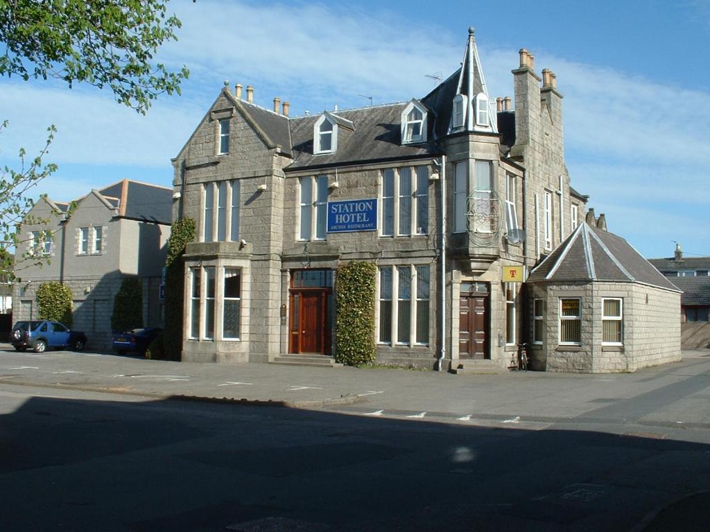 an old building on the corner of a street at Station Hotel in Ellon