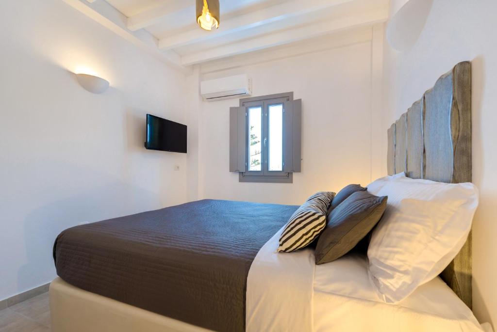 Postel nebo postele na pokoji v ubytování White Harmony Suites