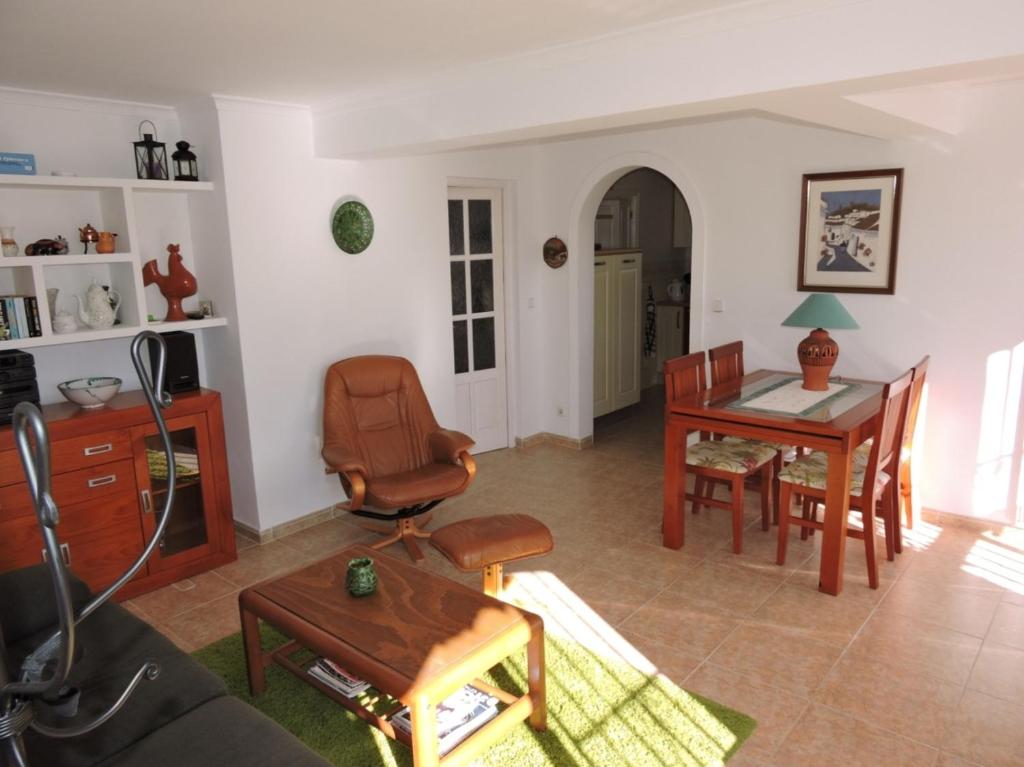 a living room with a table and a chair at Nerja Villas-Capistrano in Nerja