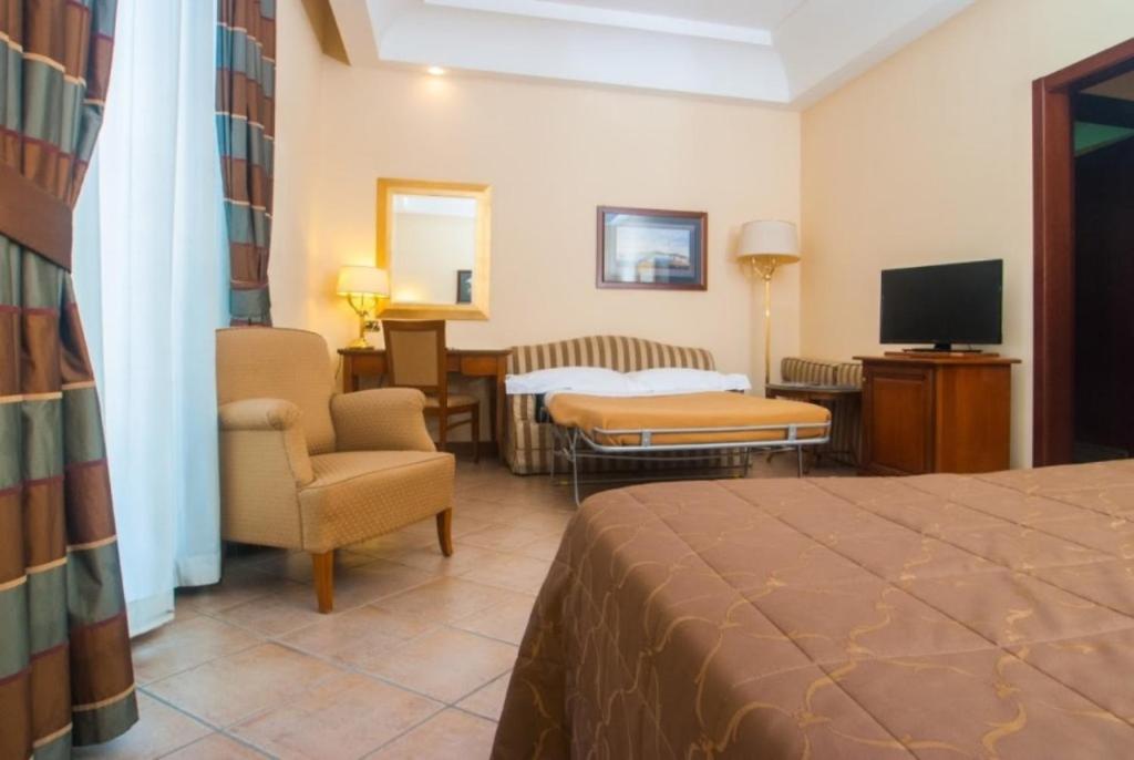 TV a/nebo společenská místnost v ubytování Le Cheminée Business Hotel Napoli