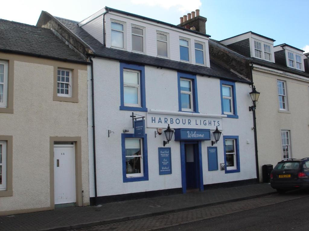 a blue and white building on a street at Harbourlights Accomodation in Irvine