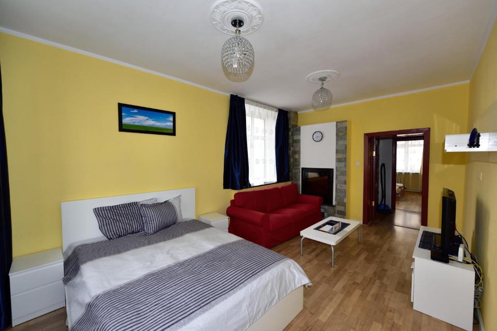 a bedroom with a bed and a red chair at T apartment in Ulaanbaatar