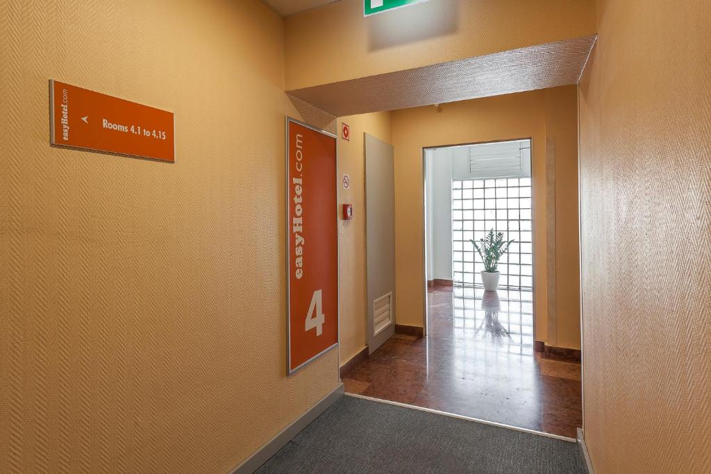 a hallway in a hospital with a sign on the wall at easyHotel Budapest Oktogon in Budapest