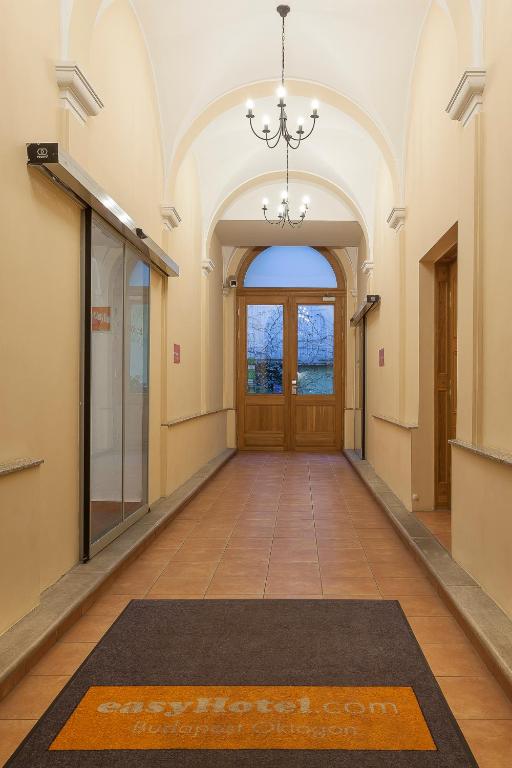 an empty hallway with a door and a rug on the floor at easyHotel Budapest Oktogon in Budapest