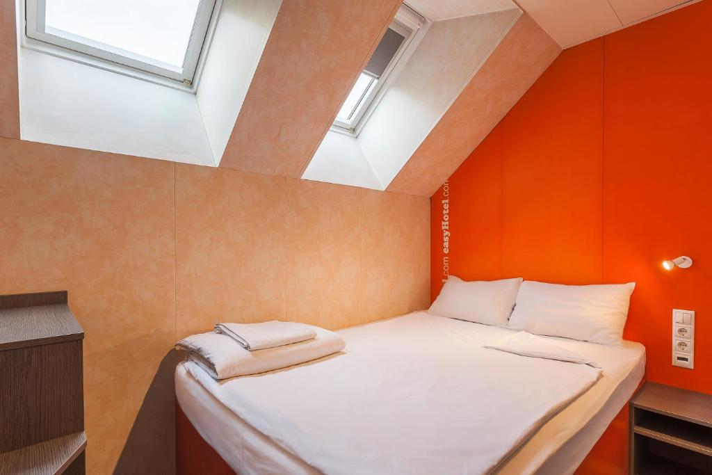 a small bed in a room with a window at easyHotel Budapest Oktogon in Budapest