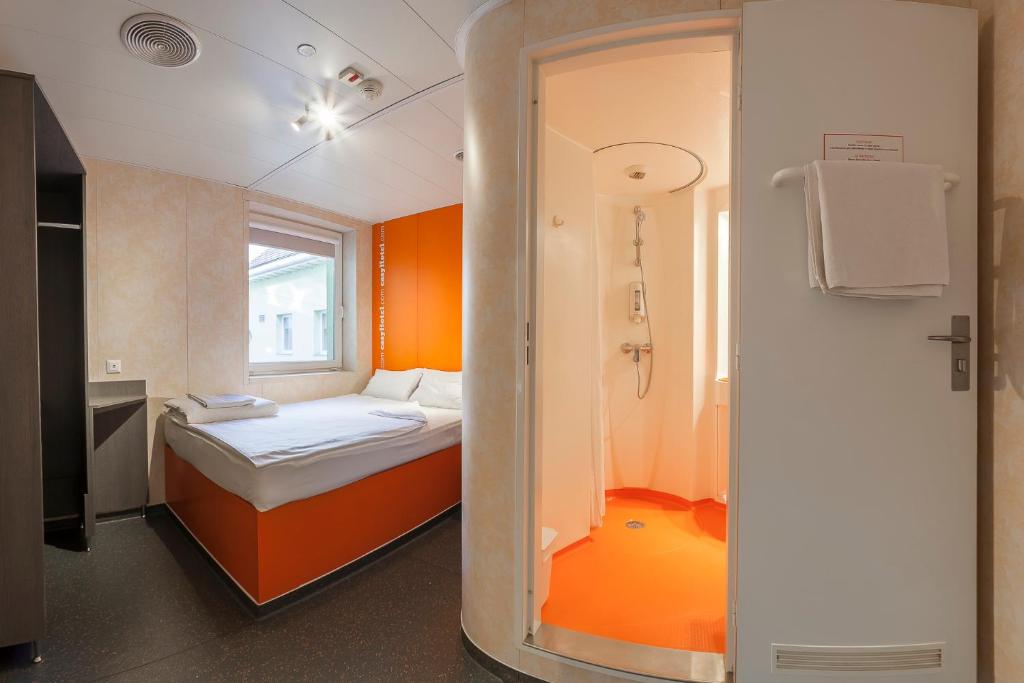 a small room with a bed and a window at easyHotel Budapest Oktogon in Budapest