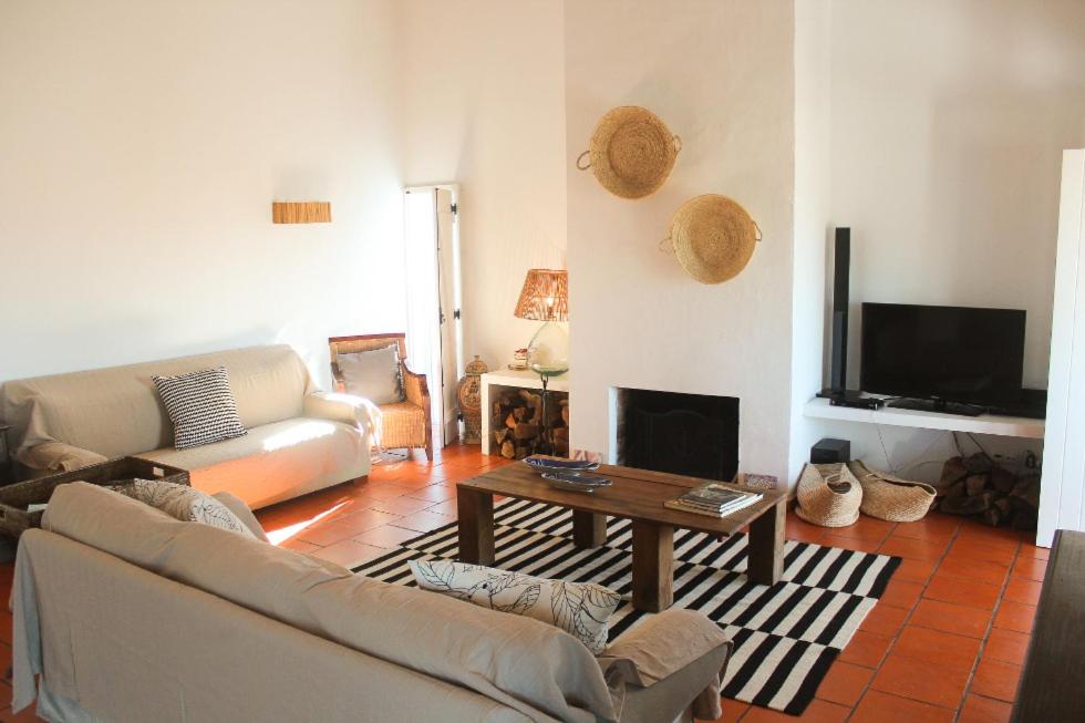 a living room with a couch and a coffee table at Comporta House in Comporta
