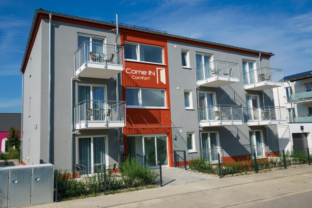 an apartment building with a red and white facade at Come IN Comfort in Ingolstadt