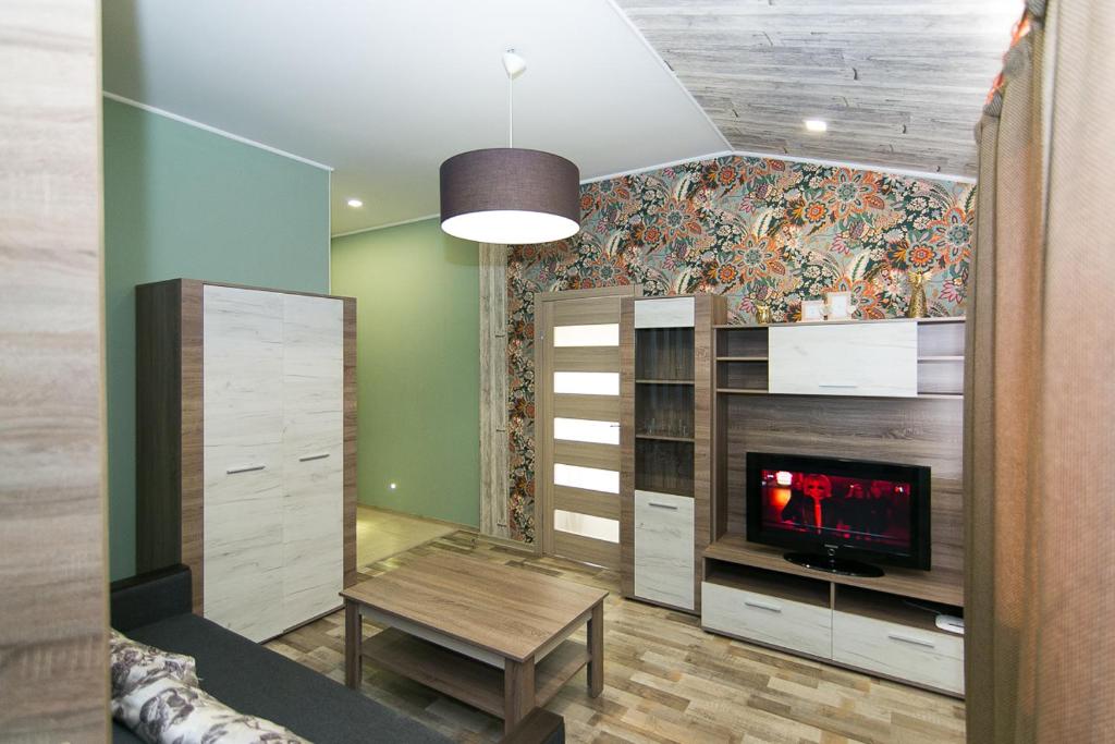 a room with a table and a wall with a mural at Apartment Faraon 5 in Sumy