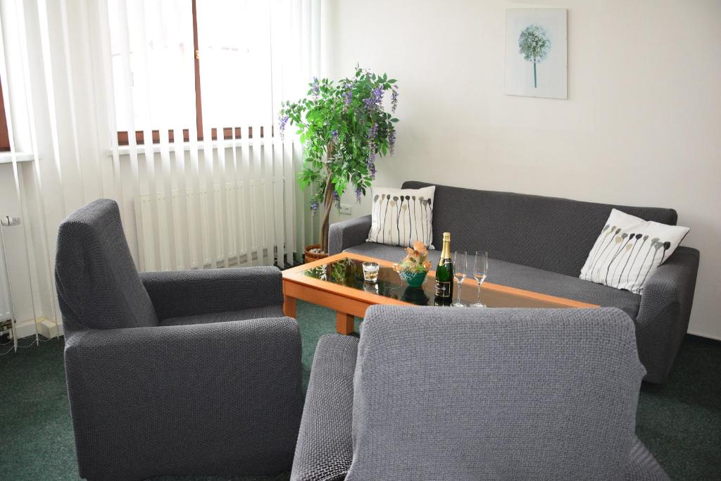 a living room with two couches and a table at Hotel Jaškovská Krčma in Horní Těrlicko