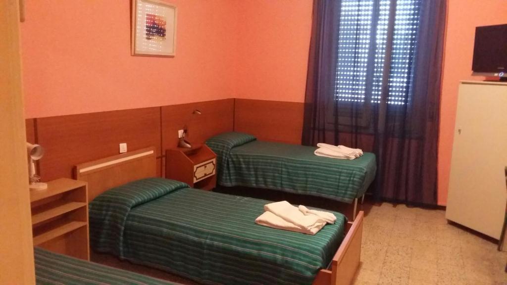 Postel nebo postele na pokoji v ubytování Hotel Violetta
