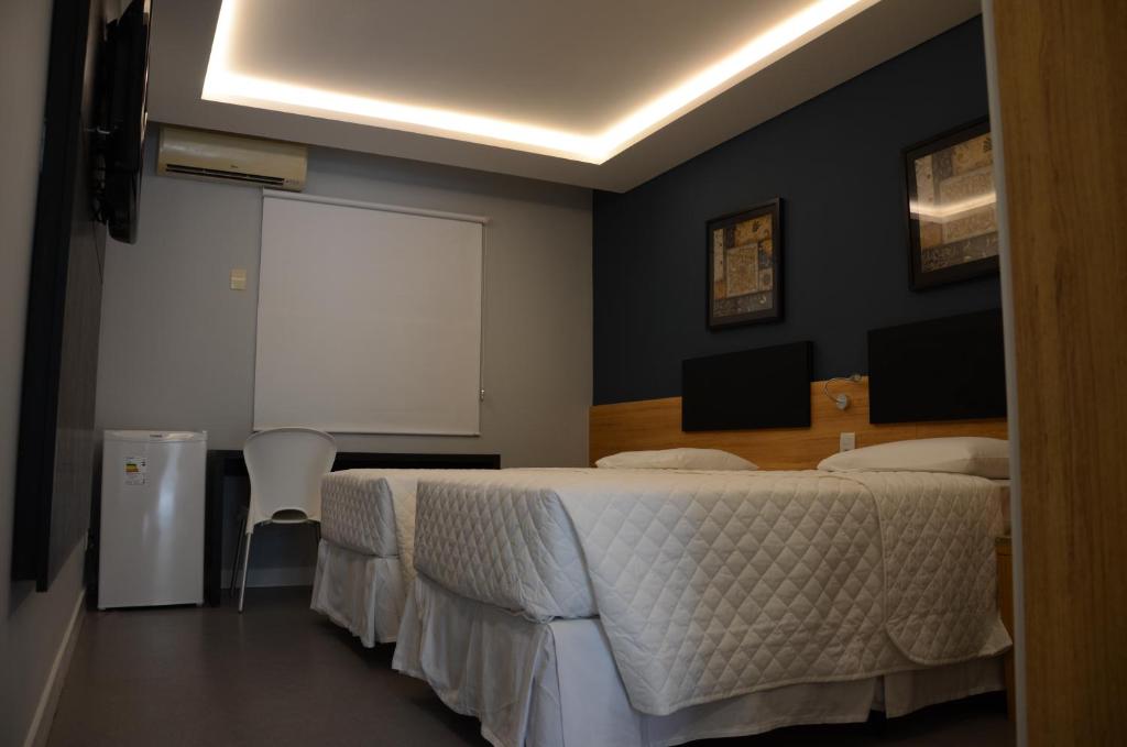 Postel nebo postele na pokoji v ubytování Hotel São Domingos