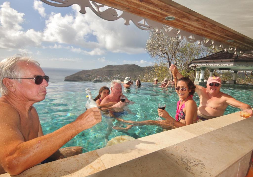 a group of people sitting in a swimming pool at Tropical Hideaway in Port Elizabeth