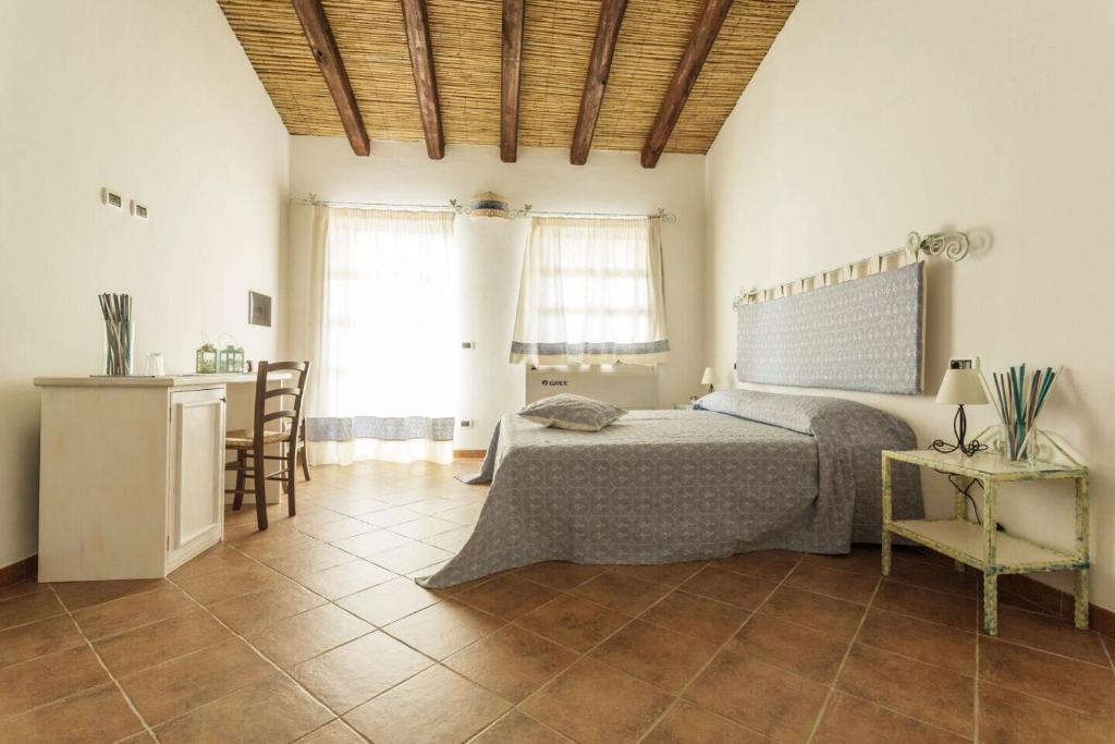 Postel nebo postele na pokoji v ubytování Villamarina Garden Relais