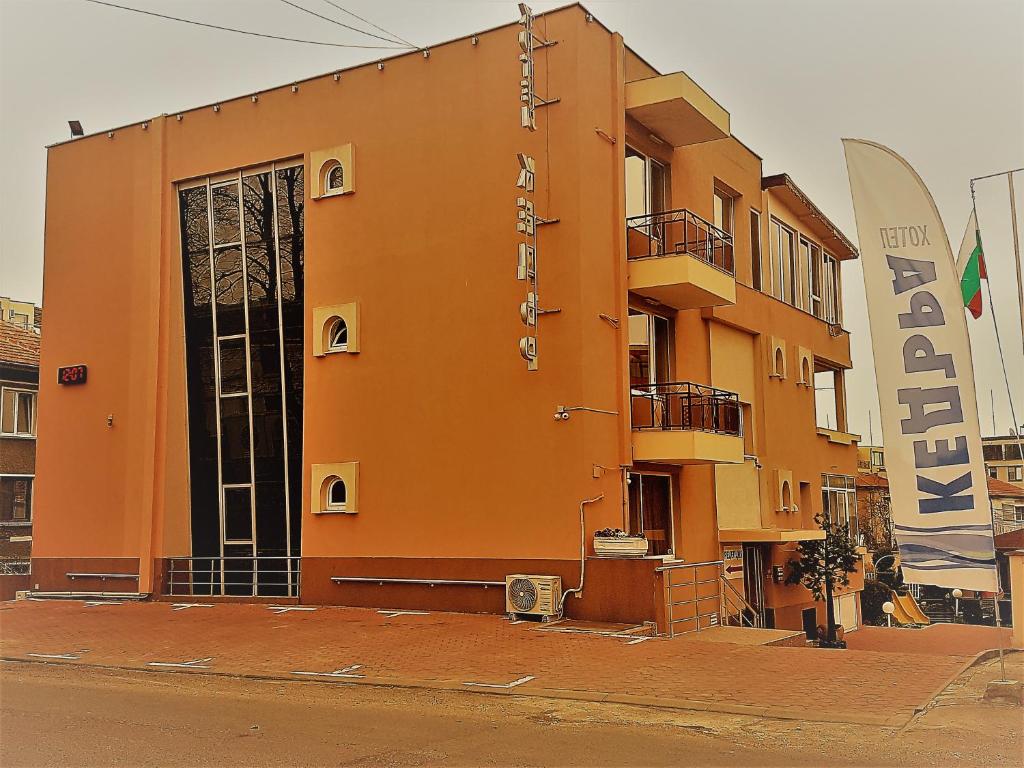 an orange building on the side of a street at Family Hotel Kedara in Burgas City