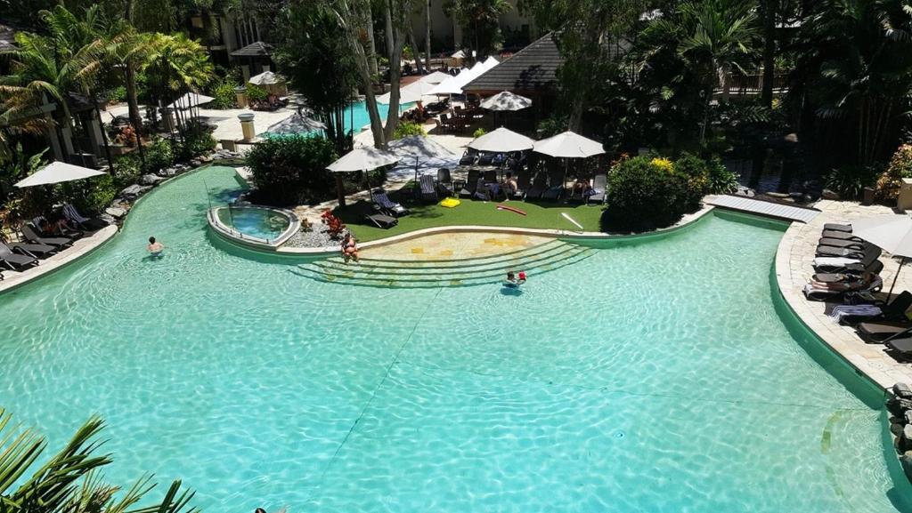 an overhead view of a swimming pool at a resort at Temple 121 Modern Spacious Palm Cove 2 Brm 2 Bth Resort Apartment With Courtyard in Palm Cove