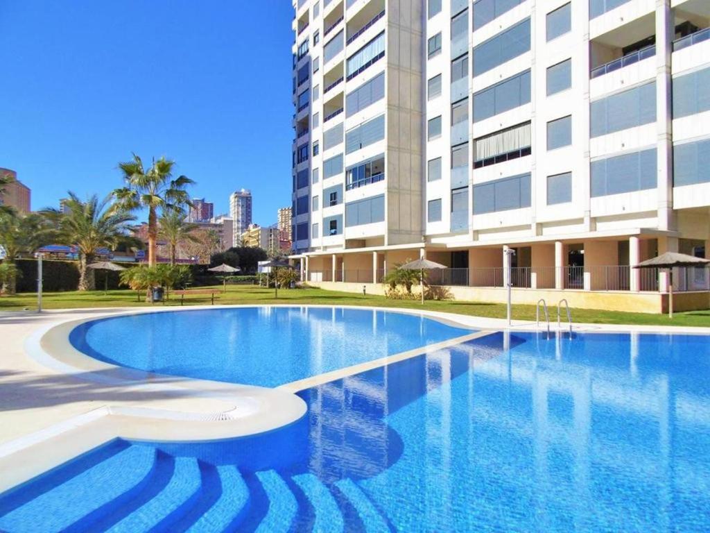 a large swimming pool in front of a building at Apartamentos Gema - Gemelos 26 in Benidorm