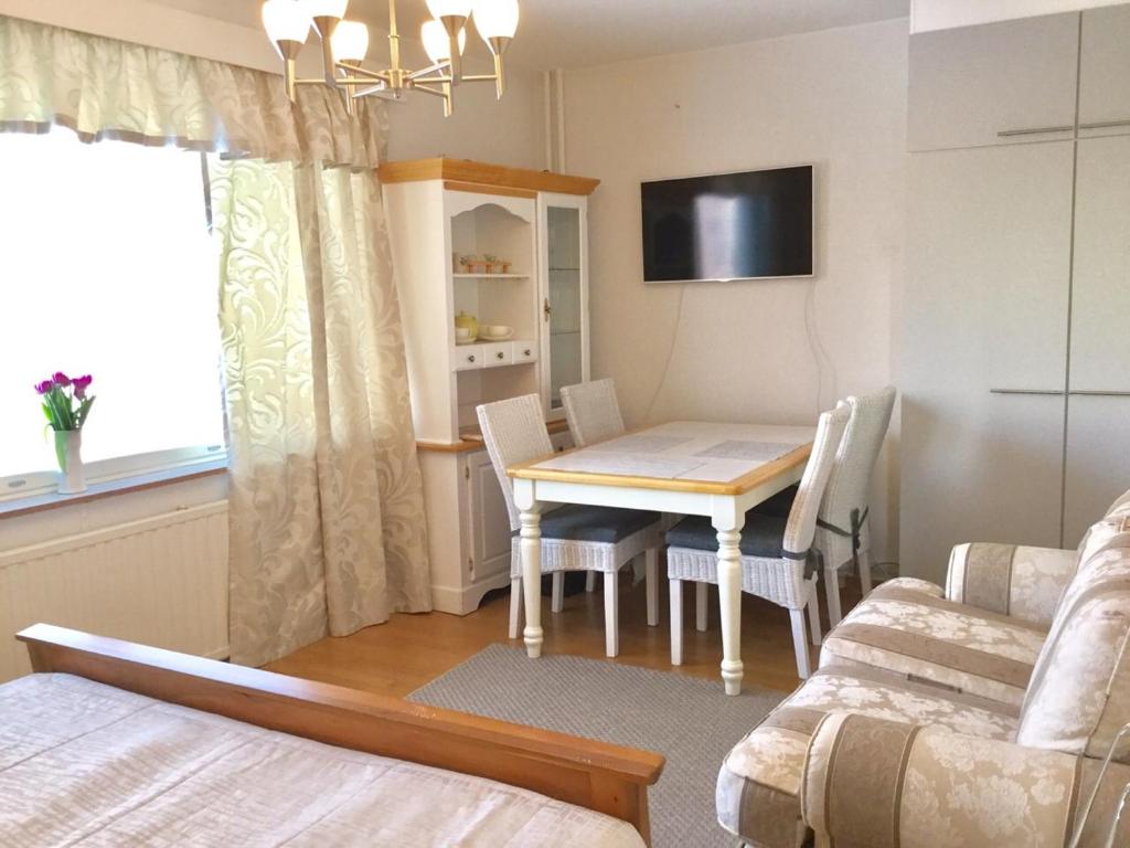 a small room with a dining room table and a bed at Ullanlinna Studio in Helsinki