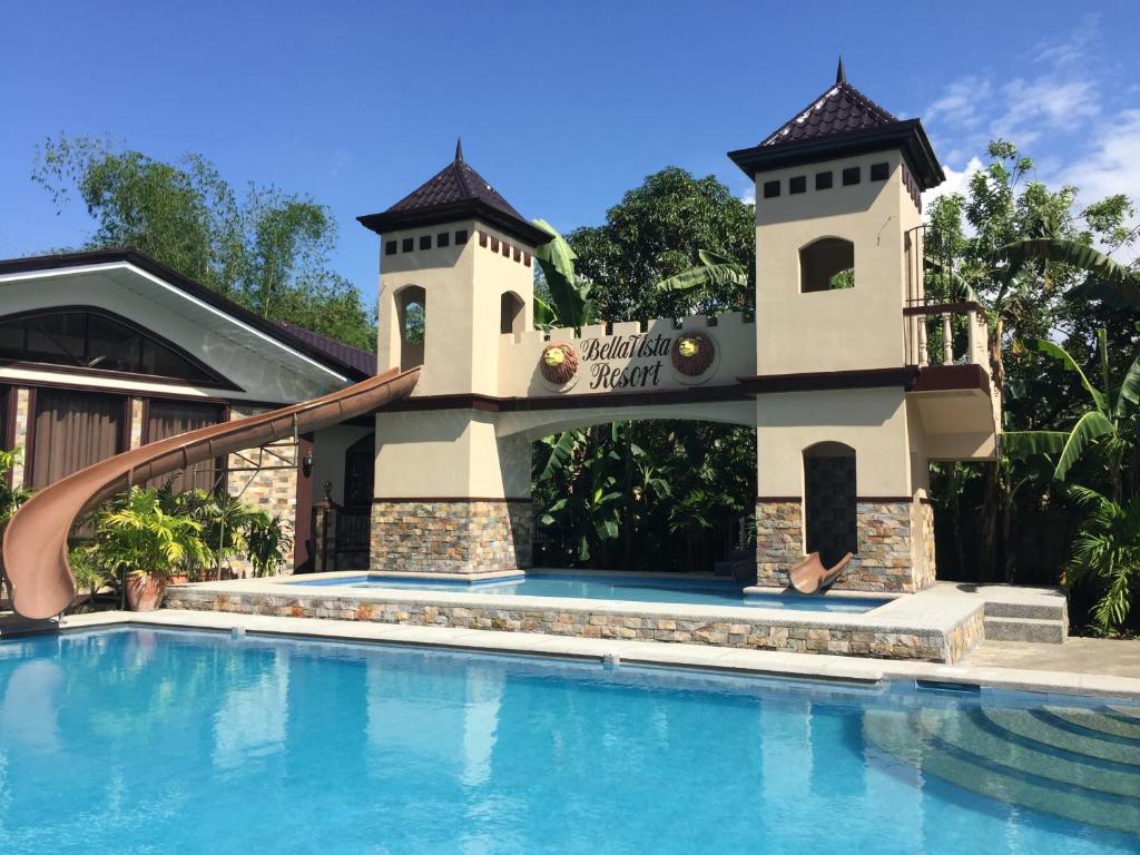 a resort swimming pool with a tower and a slide at Bella Vista Resort in Naguilian