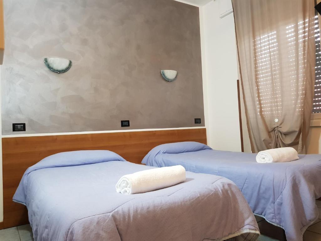 Postel nebo postele na pokoji v ubytování Hotel Marinoni