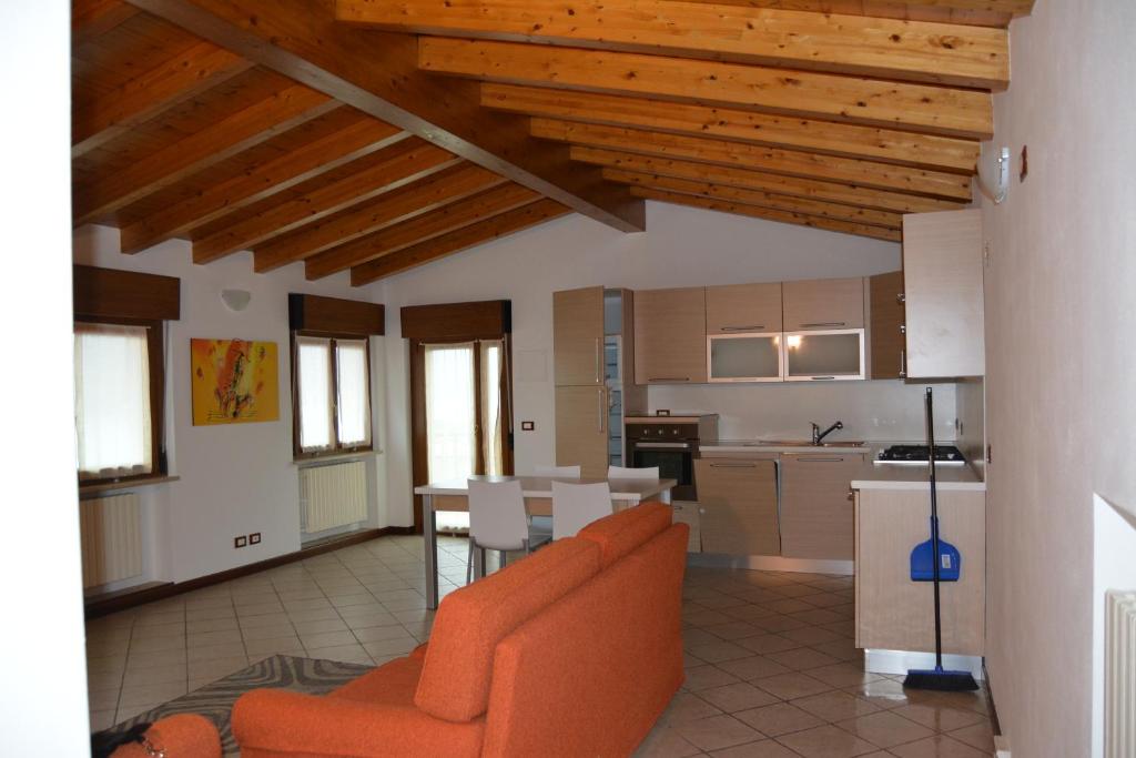 een woonkamer met een oranje bank en een keuken bij holiday on the island in Monte Isola