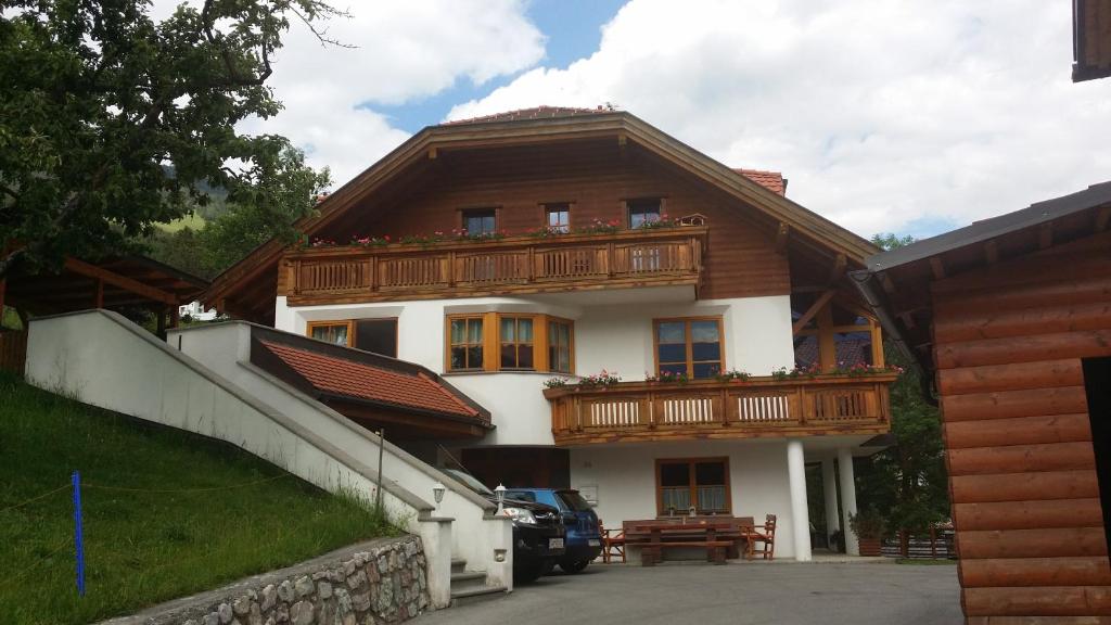 a house with wooden balconies on top of it at Haus Wieder in Fliess