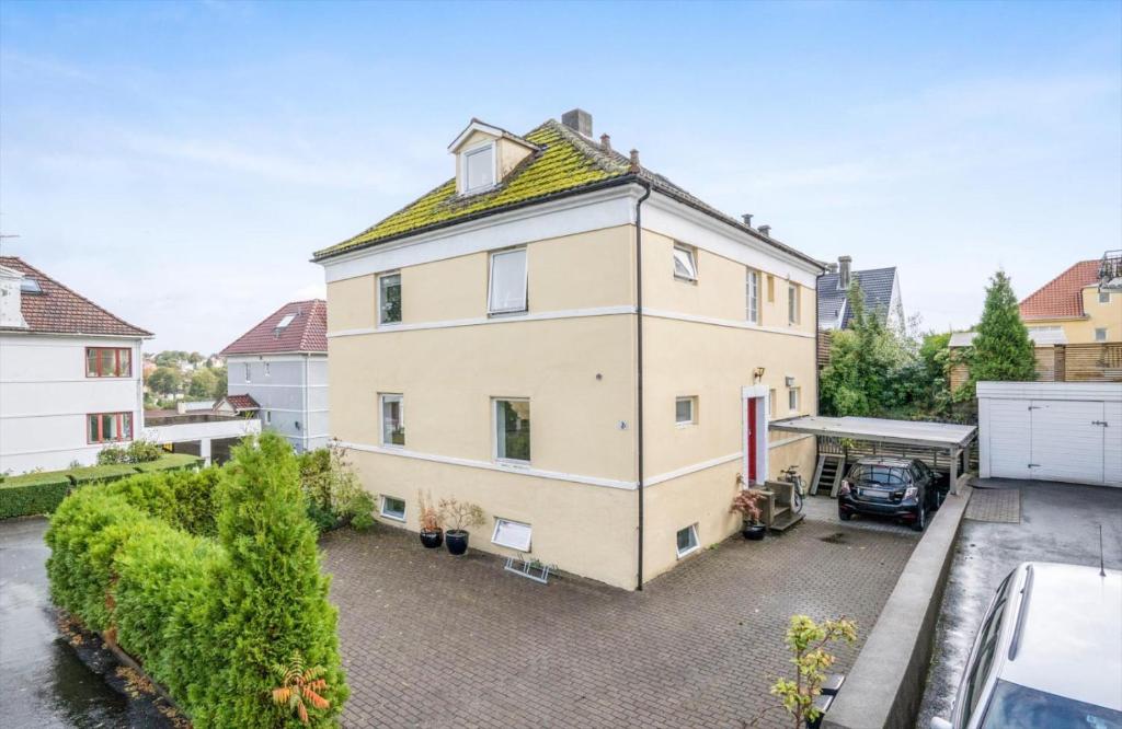an apartment building with a car parked in a parking lot at Grand Villa Stavanger in Stavanger