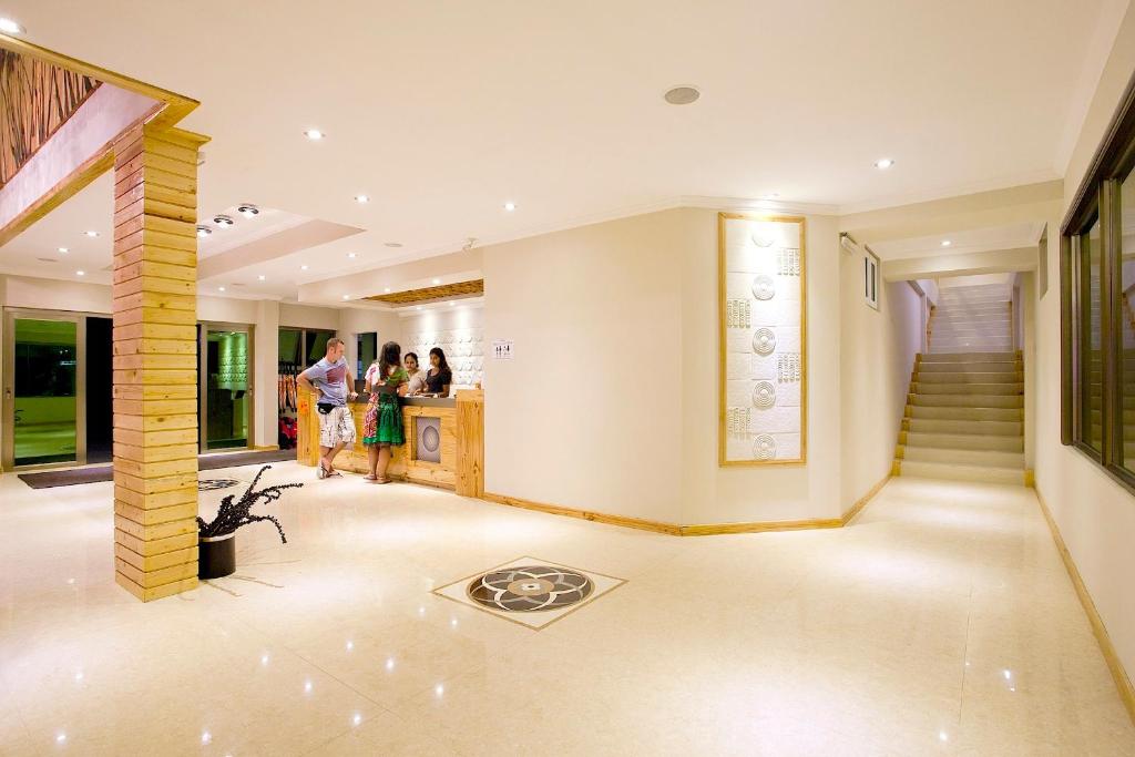 a group of people standing in a lobby at Kaani Beach Hotel in Maafushi