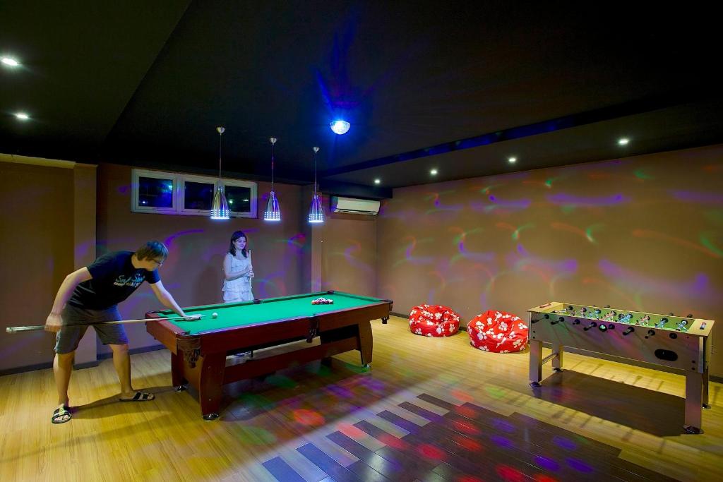 a man playing pool in a ping pong room at Kaani Beach Hotel in Maafushi
