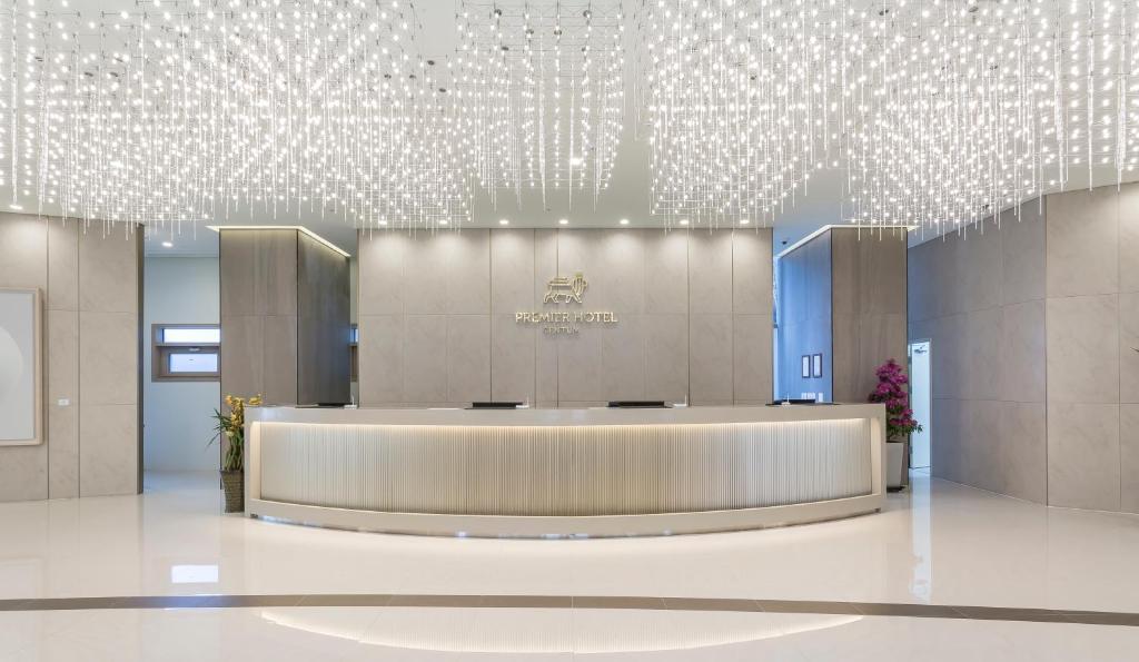 a lobby with a large reception desk in a building at Centum Premier Hotel in Busan