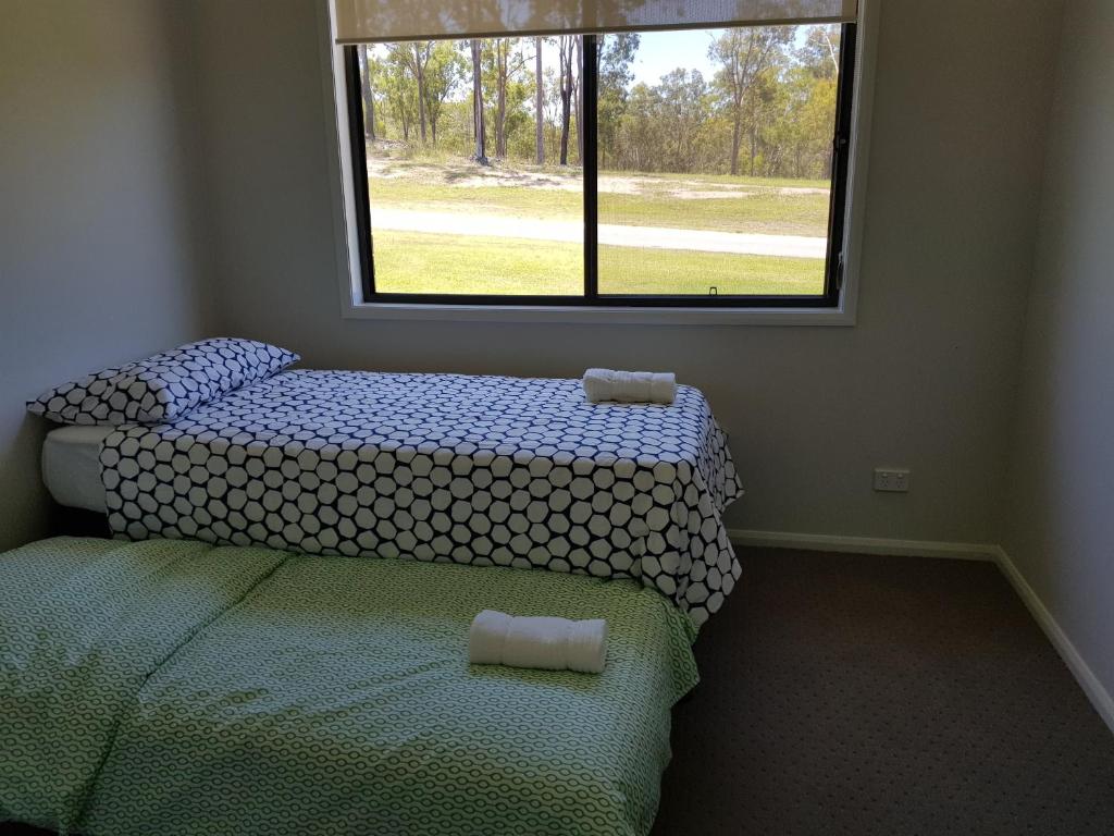 Postel nebo postele na pokoji v ubytování Adwaga Lodge