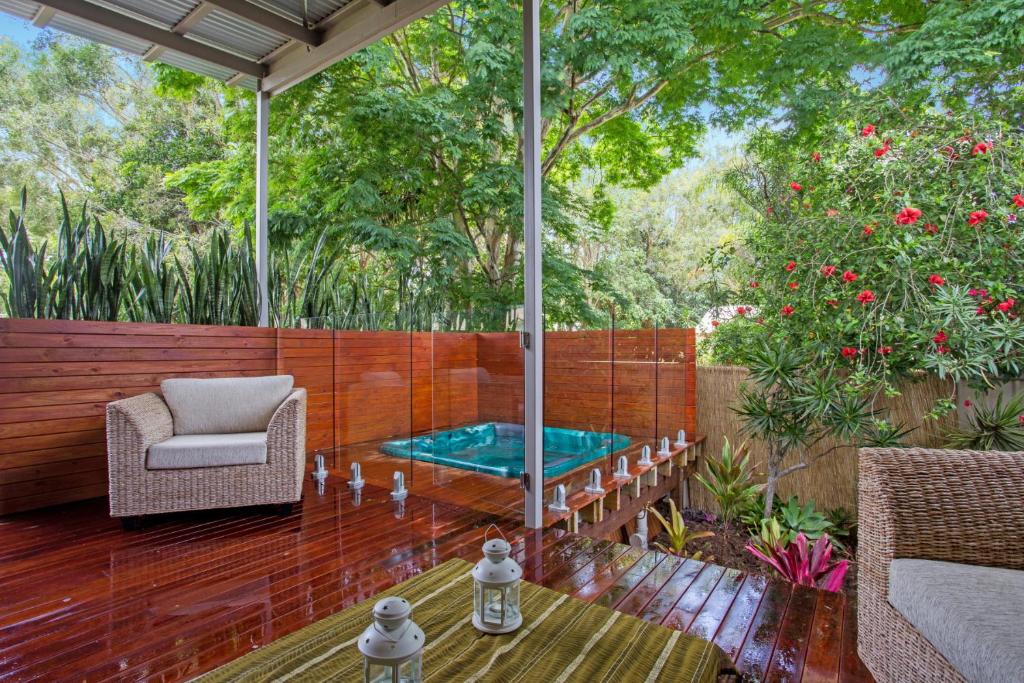 eine Terrasse mit einem Billardtisch und einem Stuhl in der Unterkunft Beach Cottage on Cassia Avenue, Central Coolum Beach in Coolum Beach