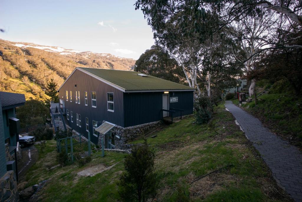 a large house with a tree on top of it at Thredbo YHA in Thredbo