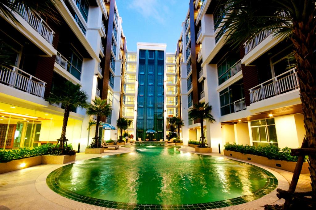 a swimming pool in the middle of a building at Art Patong Residence in Patong Beach